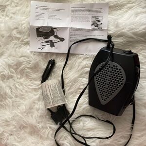 Portable auto heater. Mount w/3M tape or screws. Rotating base and has handles.